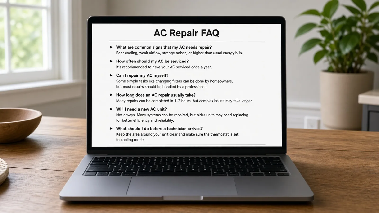 Laptop on a kitchen table showing an FAQ outline about AC repair