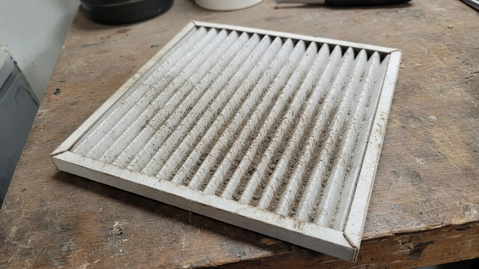 Used HVAC air filter on a workbench